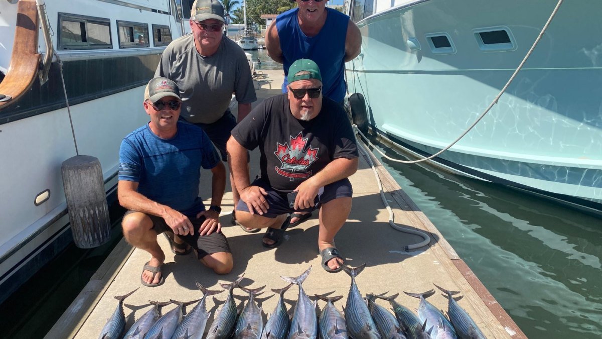 Group returning to the dock in Nuevo Vallarta after a private fishing charter, with the day's catch laid out