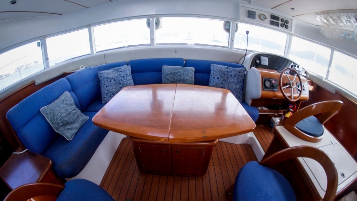Shaded interior salon and helm of a Power Cat 43 catamaran available for private yacht charter in Marina Vallarta, Puerto Vallarta